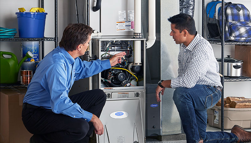 HVAC technician evaluating a furnace for repair or replacement in Thornton