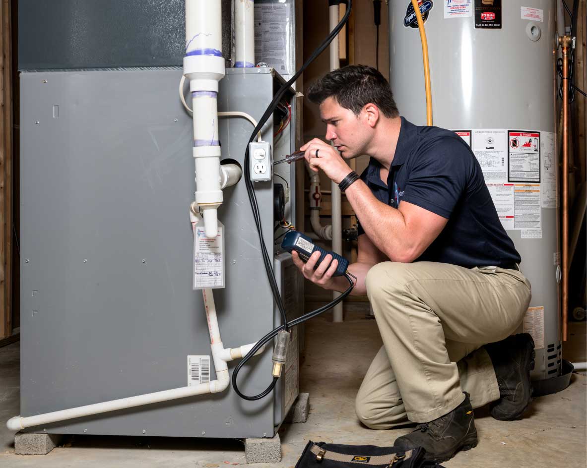 HVAC technician performing a furnace tune-up in Thornton
