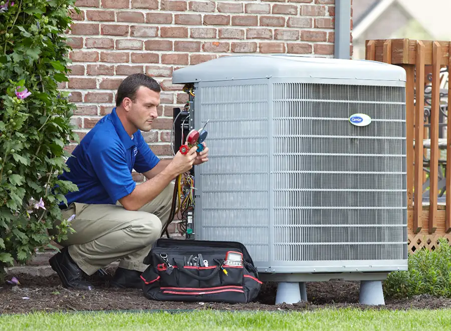HVAC technician inspecting an outdoor air conditioning unit in Thornton