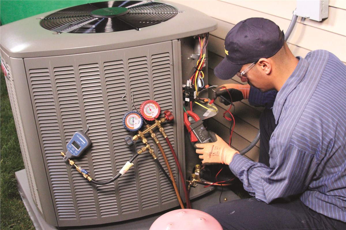 HVAC technician testing an outdoor air conditioning unit in Thornton